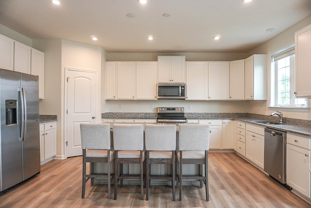 Bright white kitchen with island at 88 High St
